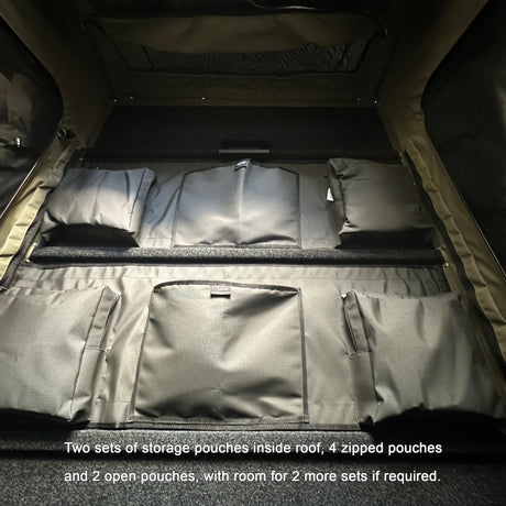 Two sets of rooftop tent organiser pouches in an AX27 roof: four zipped, two open