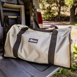 Large 86L duffle bag in olive on a ute tailgate in the bush